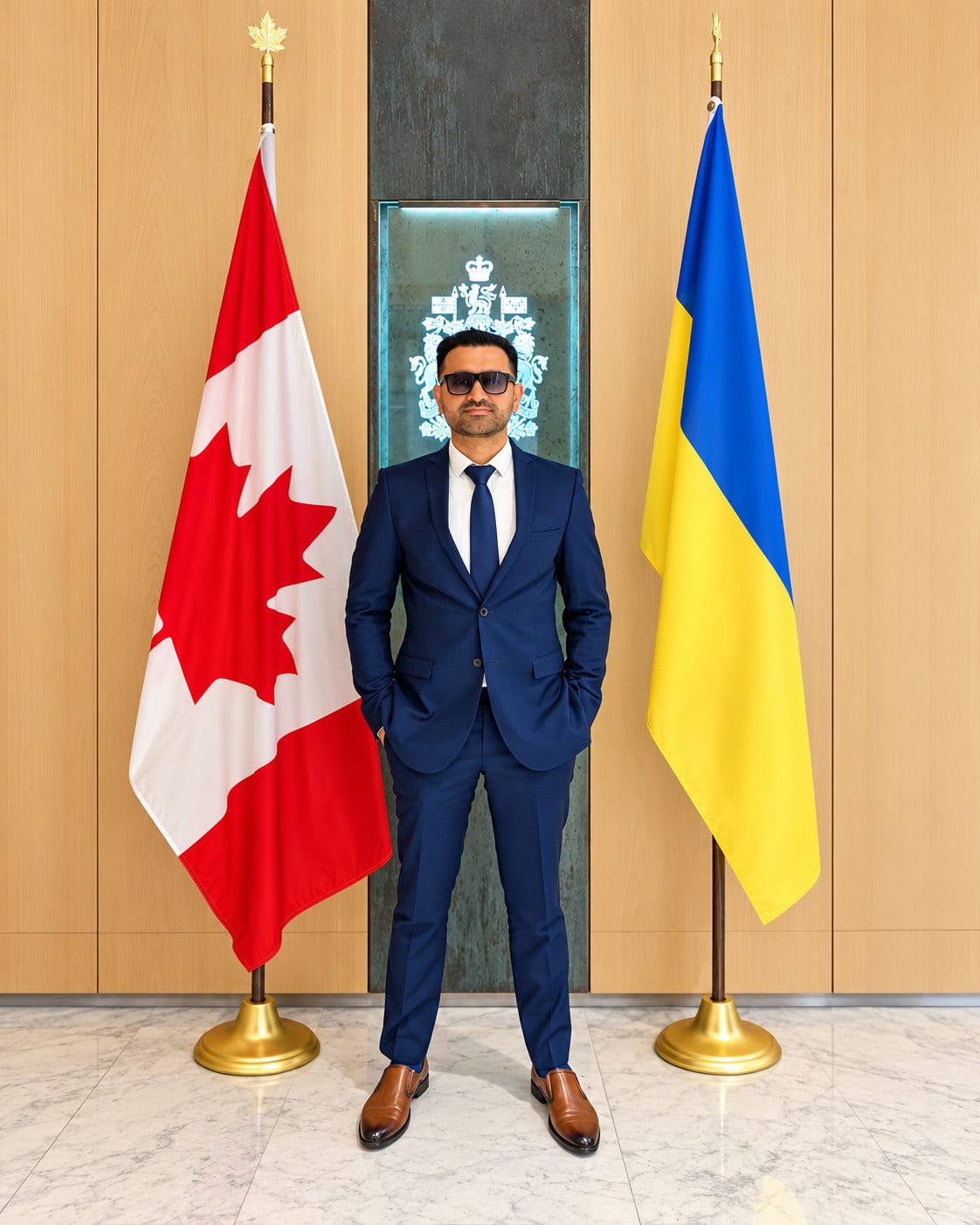 Ajlal C. Mazhar in a diplomatic reception area beside national flags.